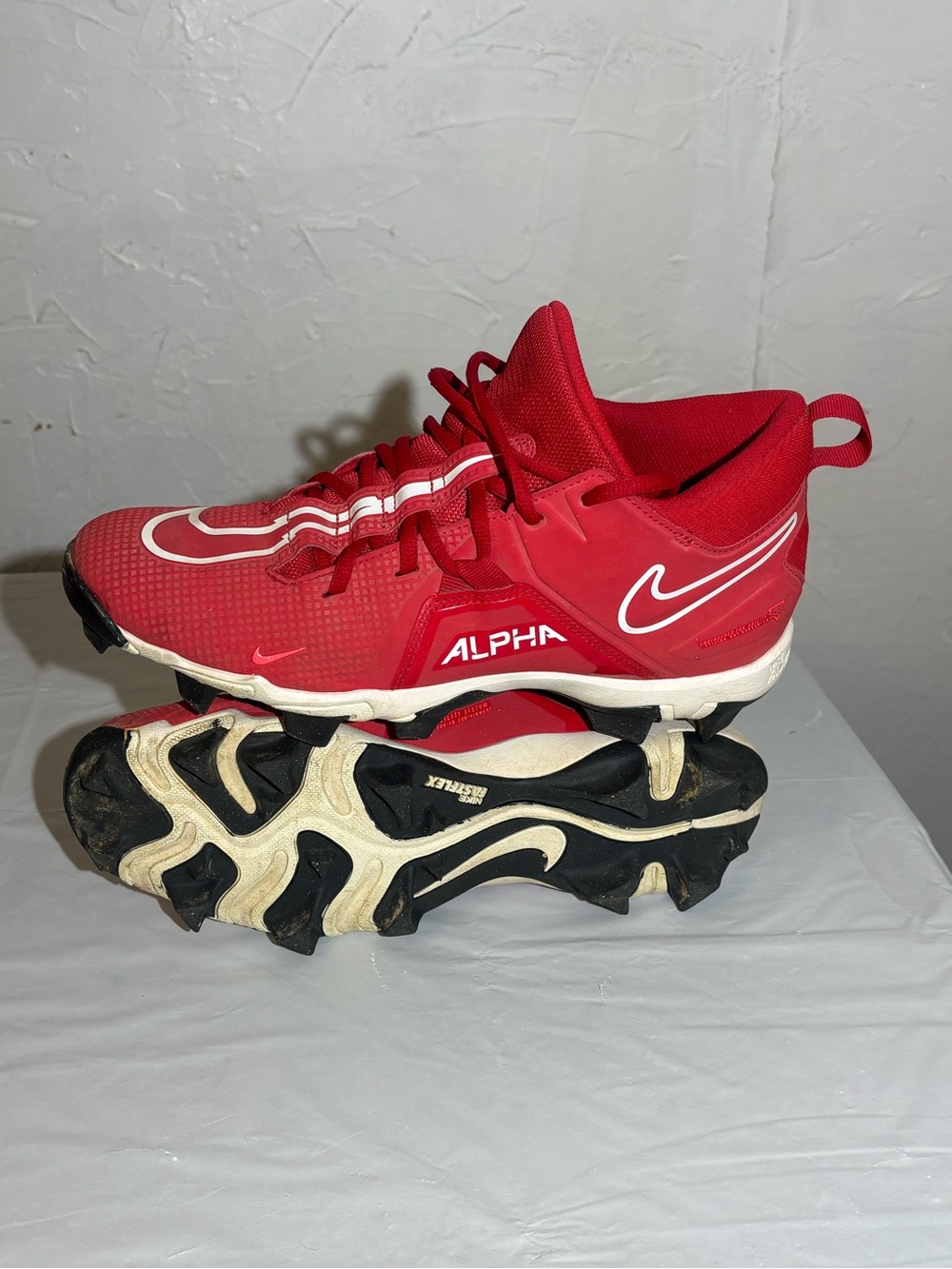 Nike Kids' Red Alpha Baseball Cleats with White Swoosh